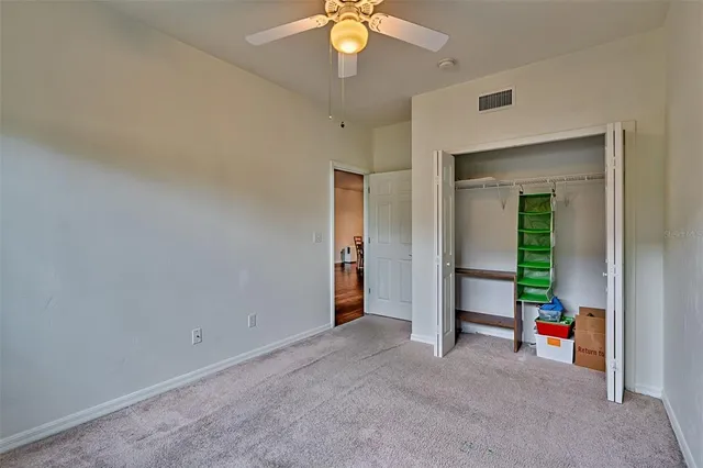 a view of an empty room with a ceiling fan
