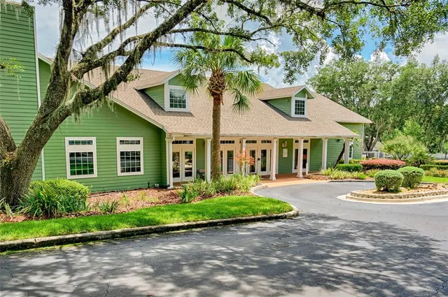 a front view of a house with a yard and outdoor seating