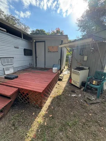 a view of a backyard with a table and chairs