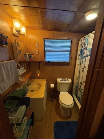 a bathroom with a toilet and a mirror