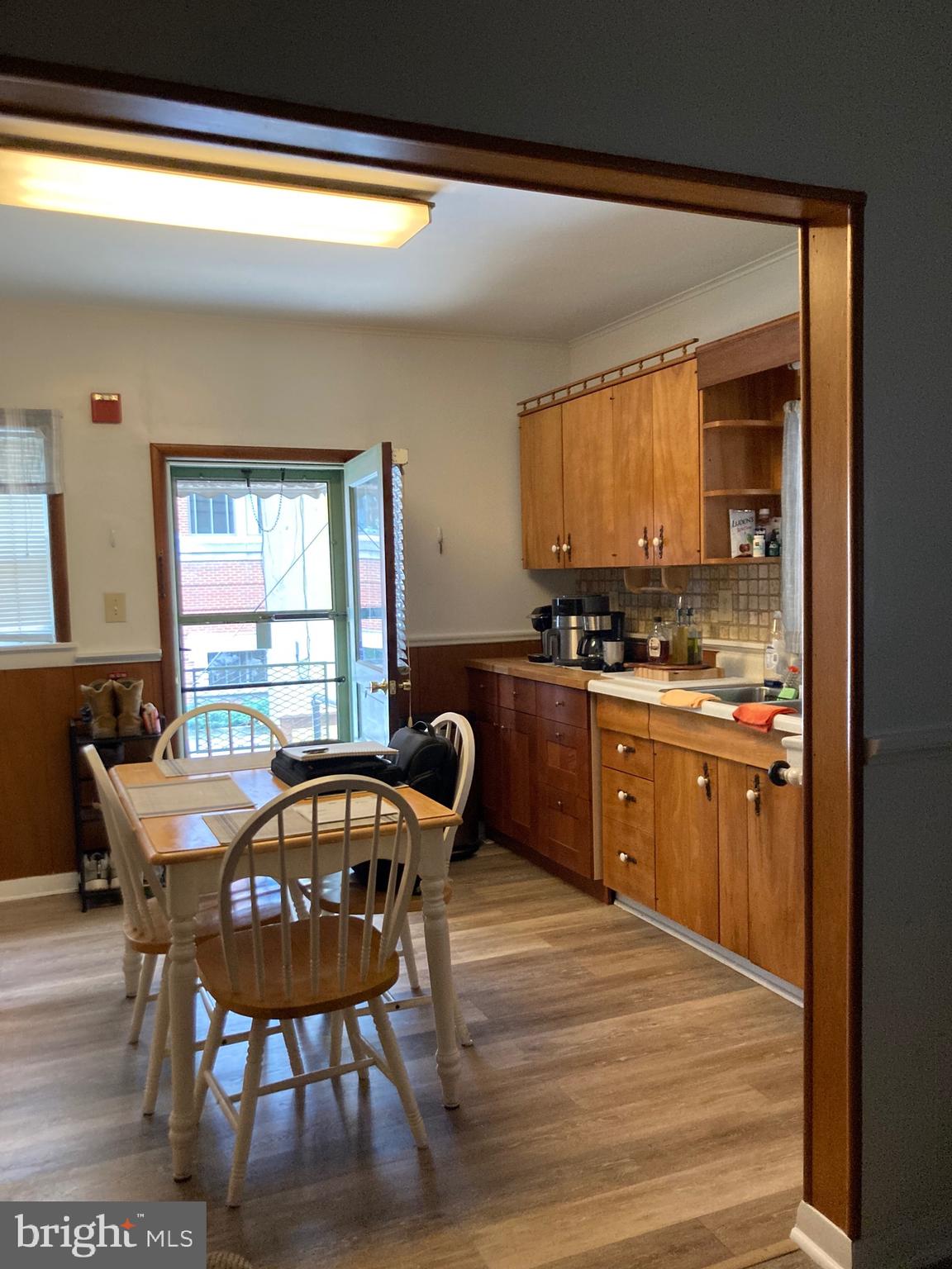 210 West Gay Street, Unit 4 West Chester, PA 19380 - Photo 4 of 6 a kitchen with stainless steel appliances granite countertop a sink a stove a table and chairs