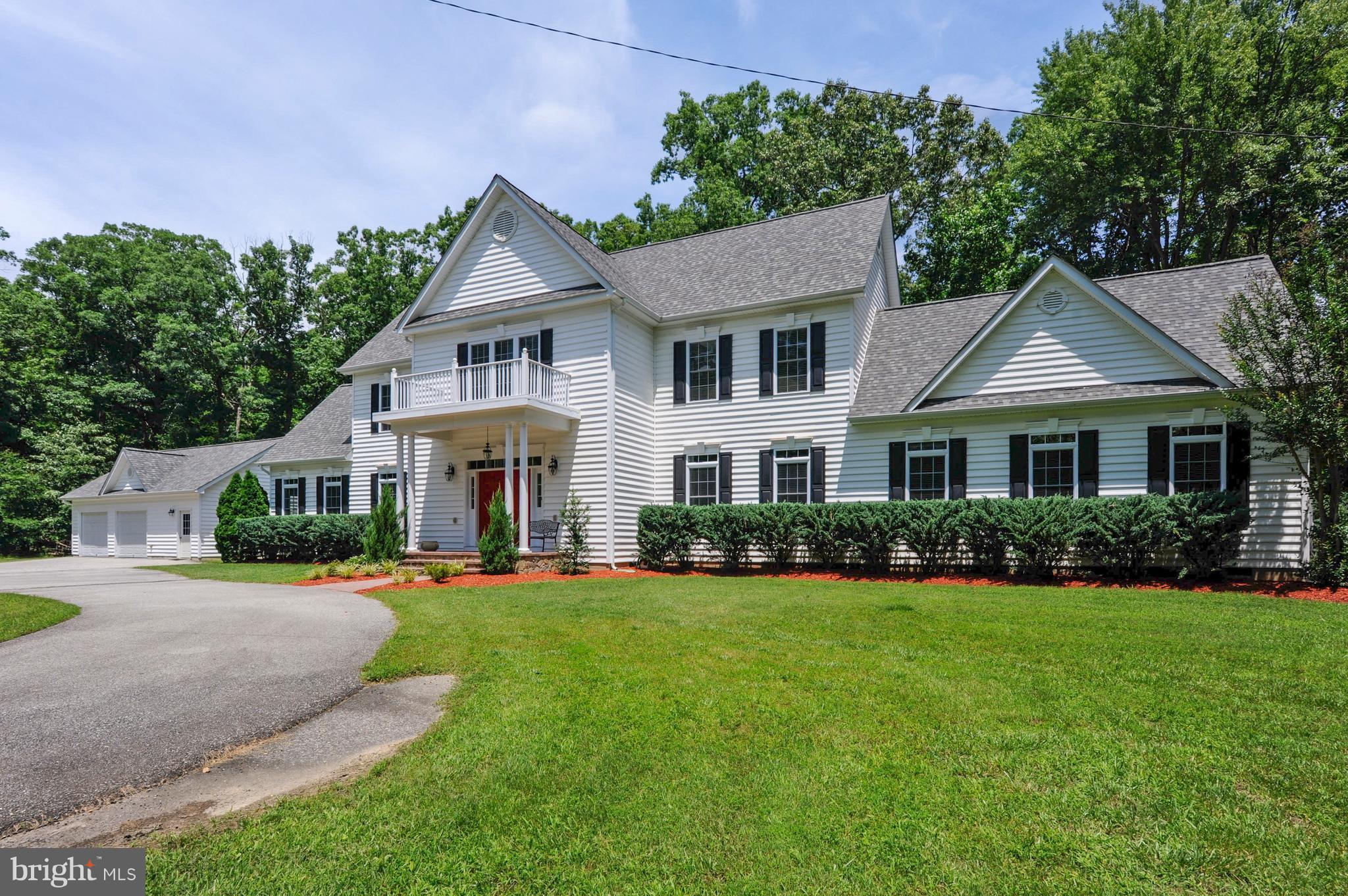 9440 Billingsley Road White Plains, MD 20695 - Photo 26 of 30 a front view of a house with a yard and garage