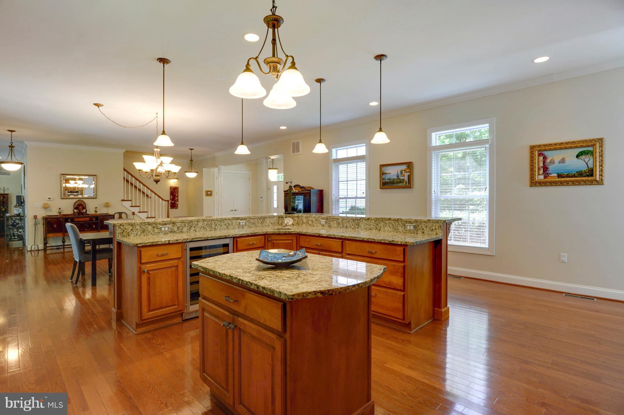 9440 Billingsley Road White Plains, MD 20695 - Photo 6 of 30 a kitchen with a sink chandelier and wooden floor