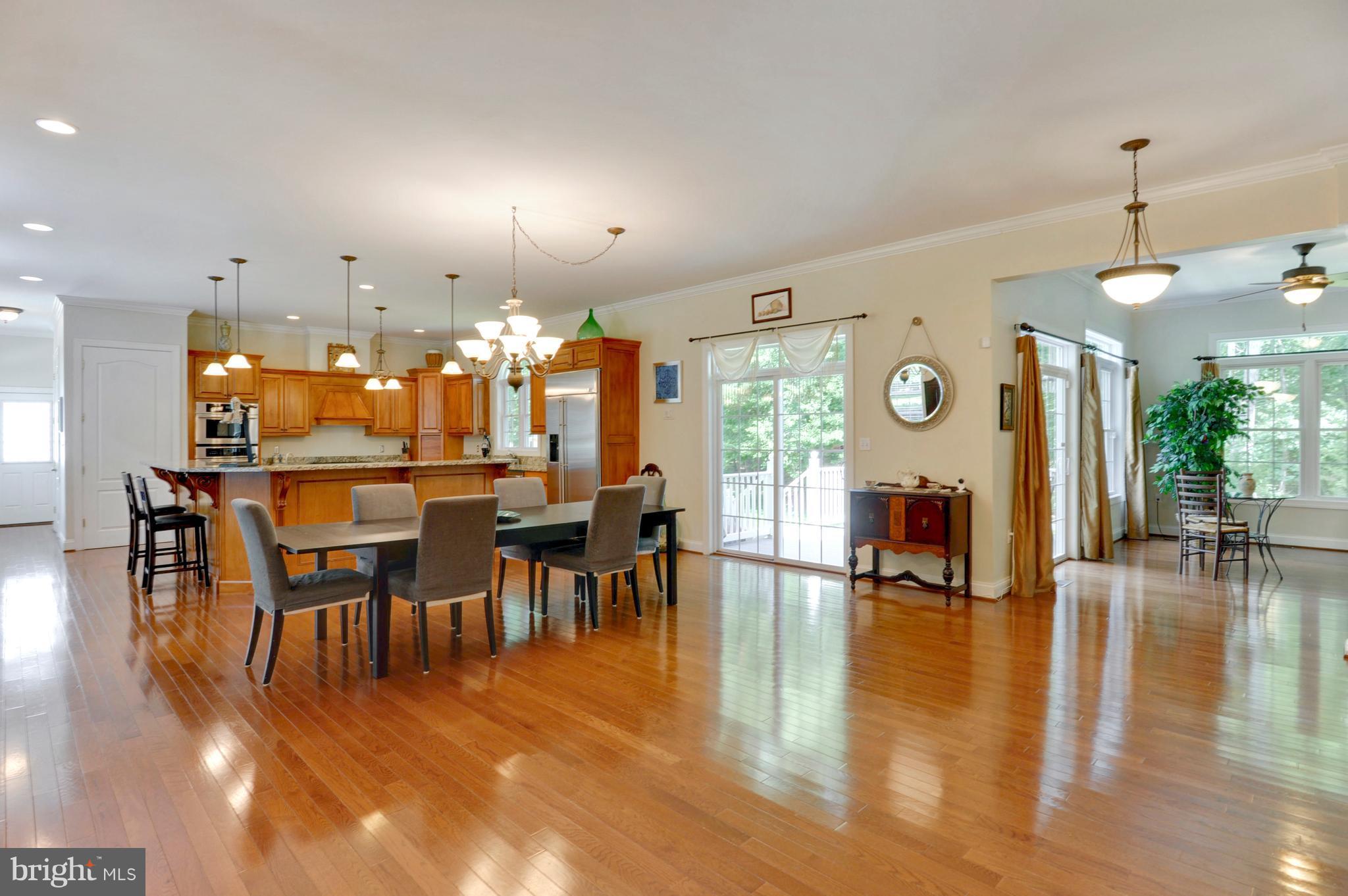 9440 Billingsley Road White Plains, MD 20695 - Photo 30 of 30 a view of a dining room and livingroom with furniture wooden floor a chandelier
