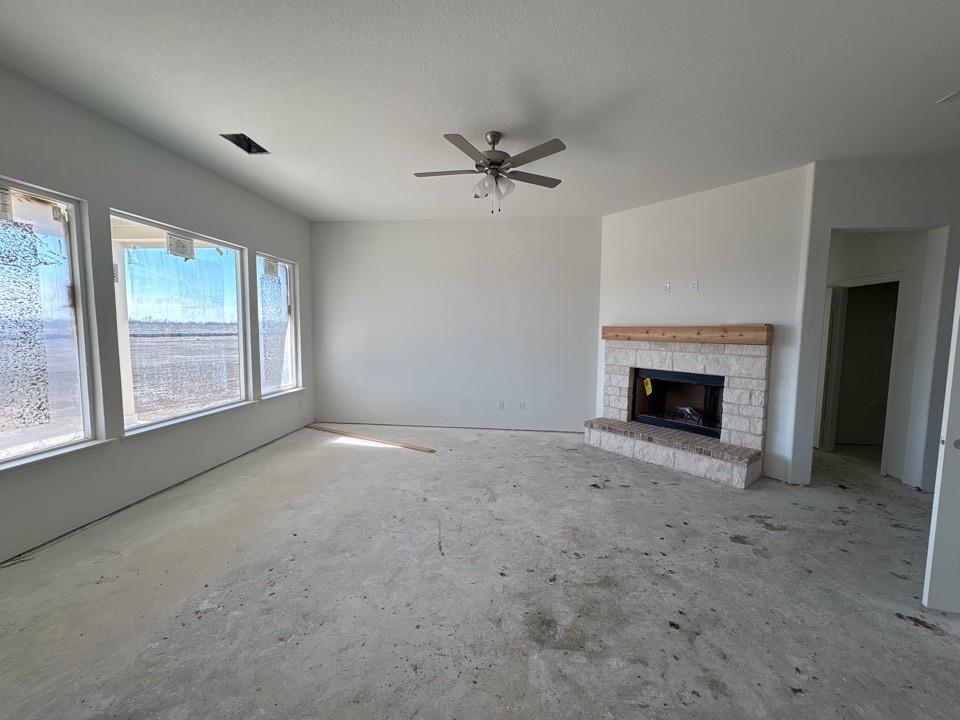 780 County Road 200 Valley View, TX 76272 - Photo 4 of 8 an empty room with windows and fireplace