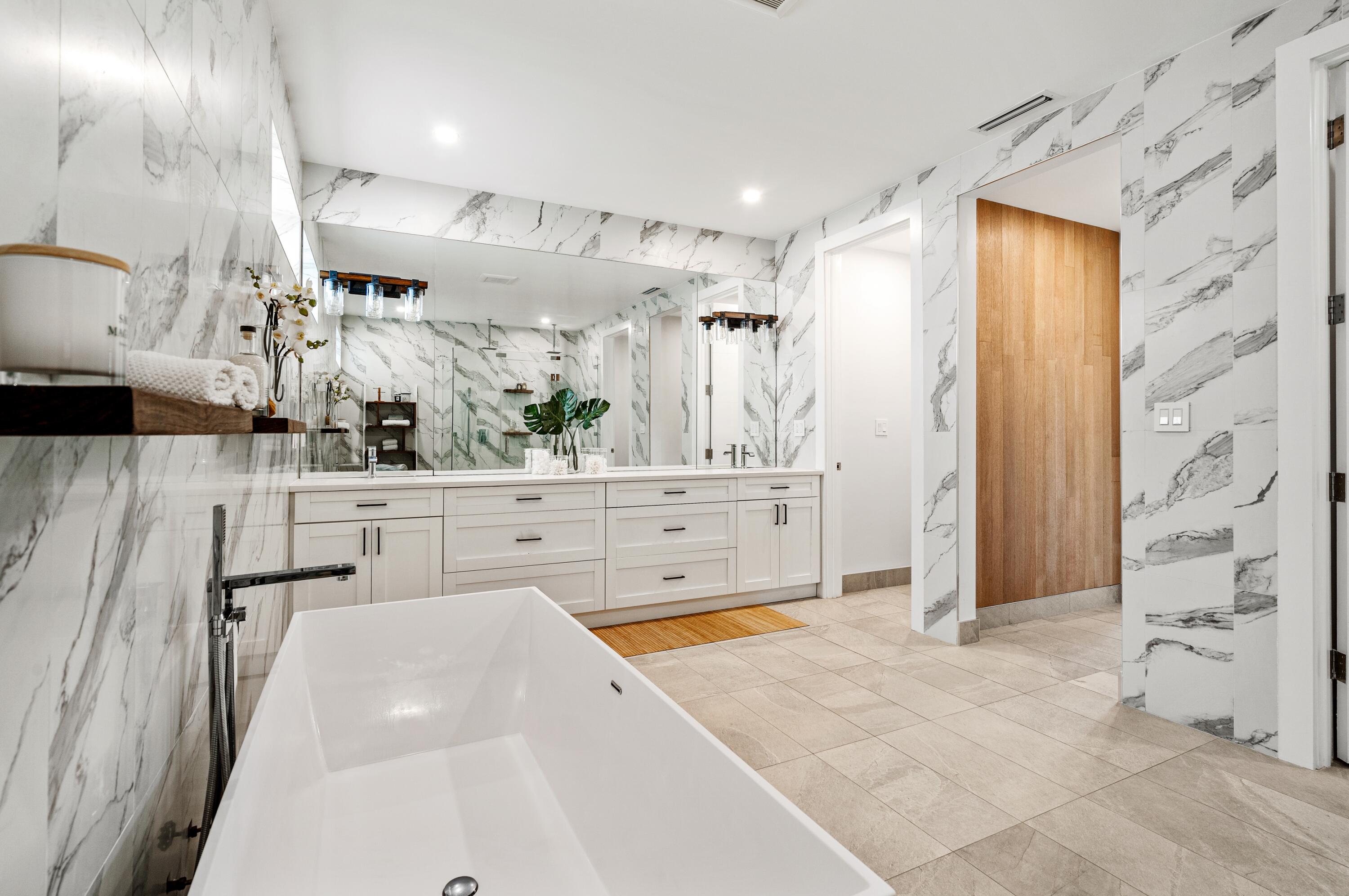 709 Northwest 6th Drive Boca Raton, FL 33486 - Photo 20 of 45 a spacious bathroom with a sink a mirror and a shower