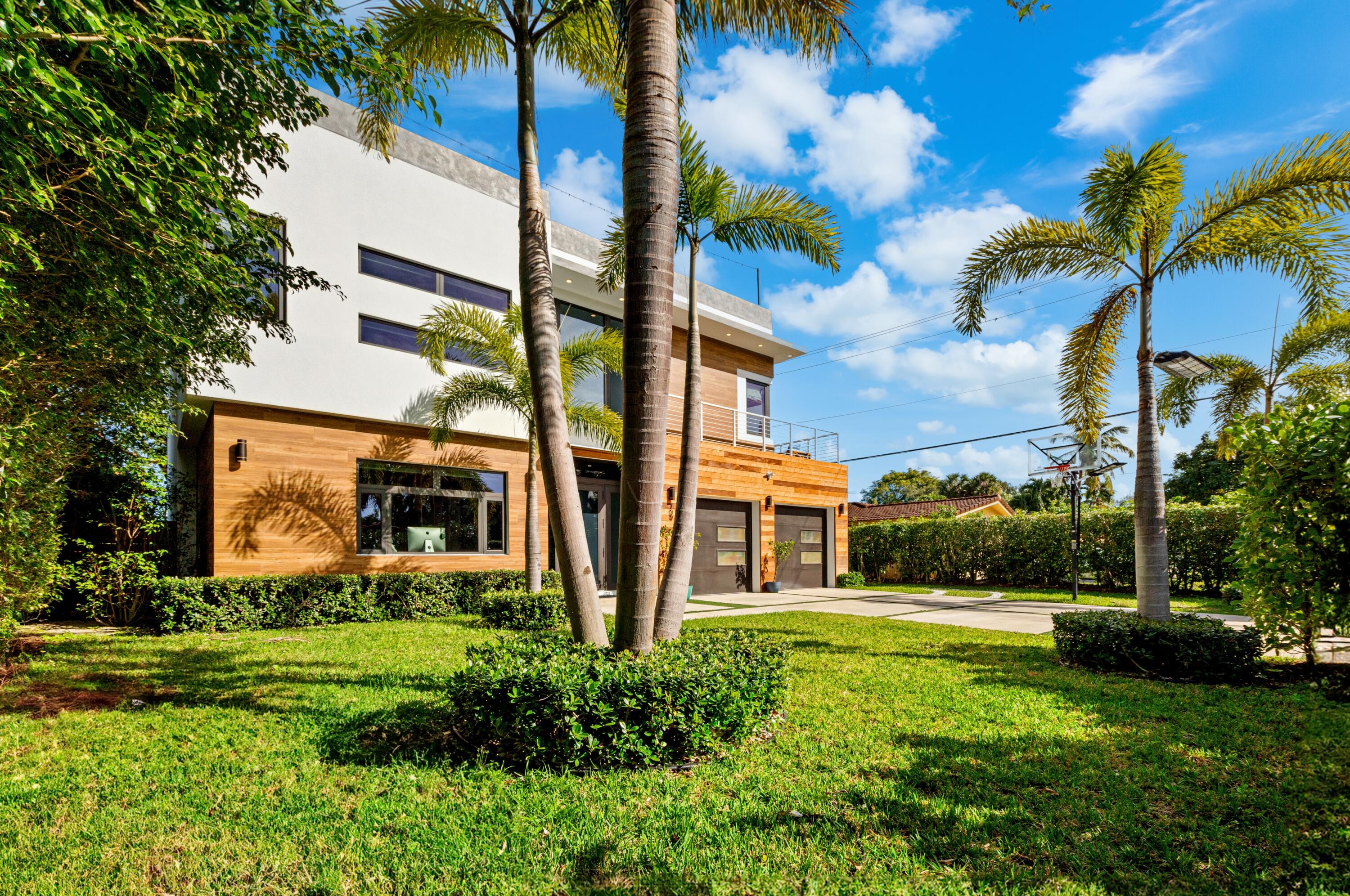 709 Northwest 6th Drive Boca Raton, FL 33486 - Photo 2 of 45 a view of a building with a yard