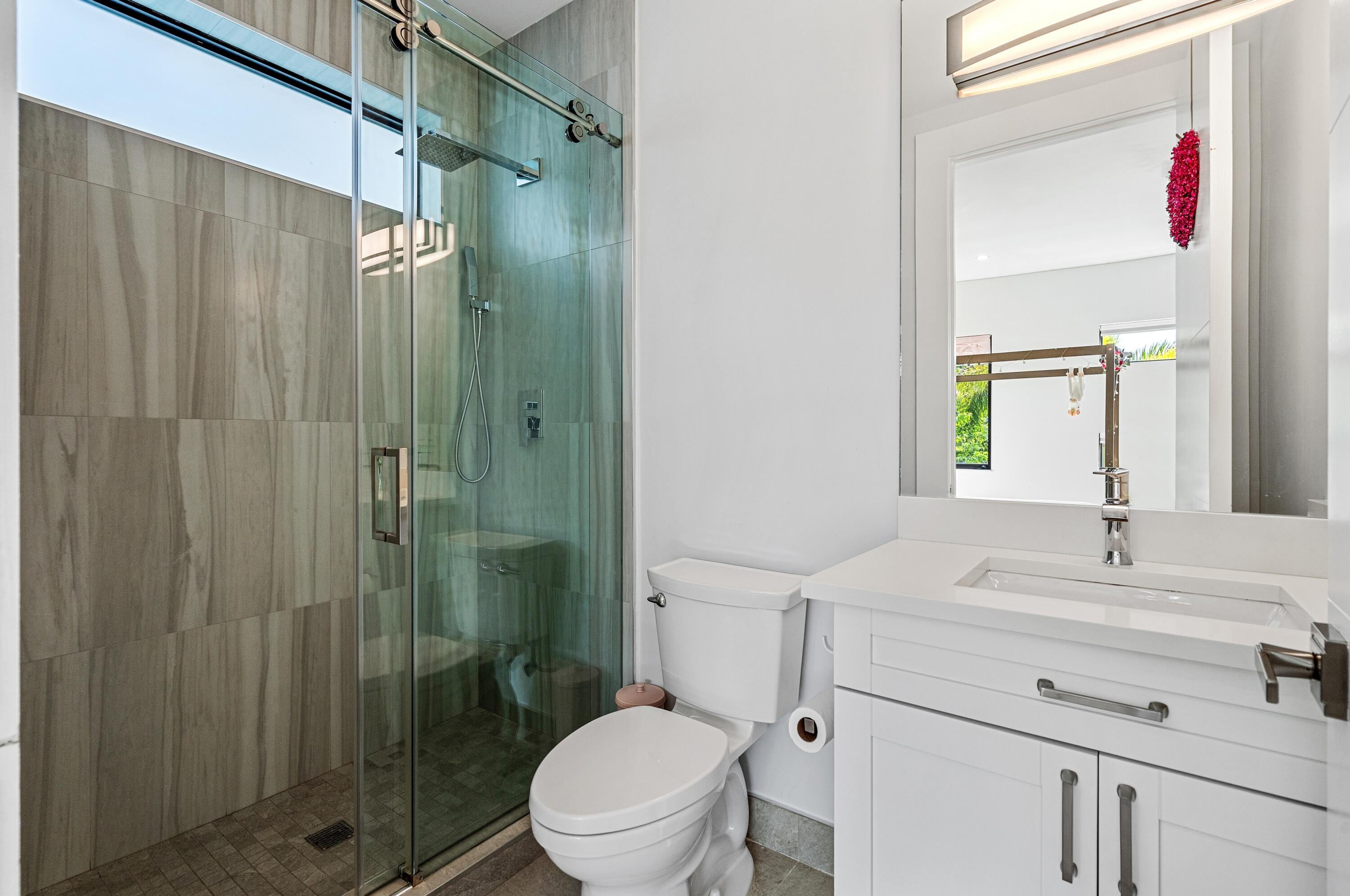 709 Northwest 6th Drive Boca Raton, FL 33486 - Photo 23 of 45 a bathroom with a sink a toilet and shower
