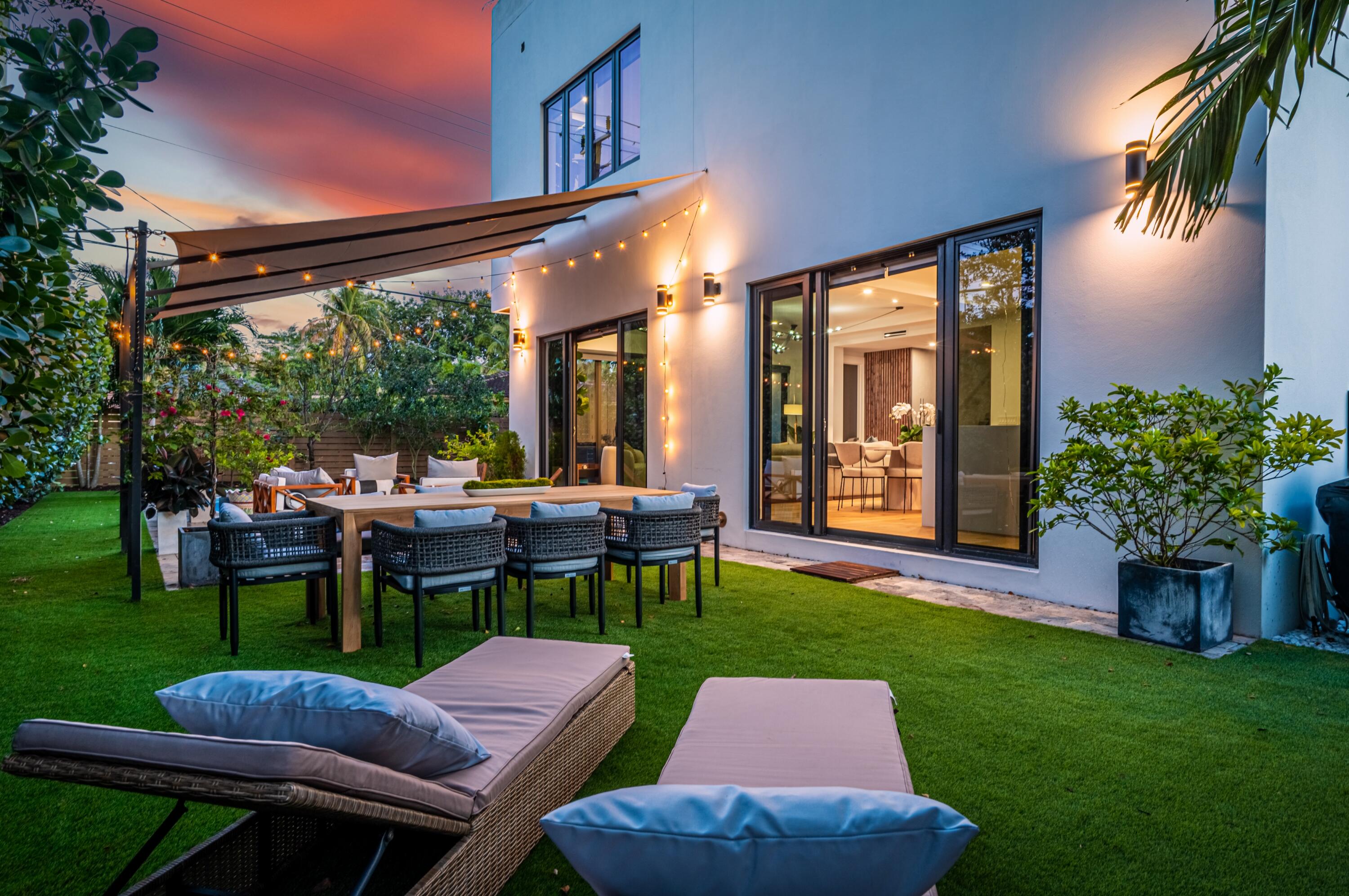 709 Northwest 6th Drive Boca Raton, FL 33486 - Photo 37 of 45 a view of a patio with table and chairs potted plants and floor to ceiling window