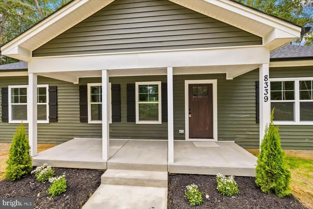 a view of a patio with a table and chairs under an umbrella