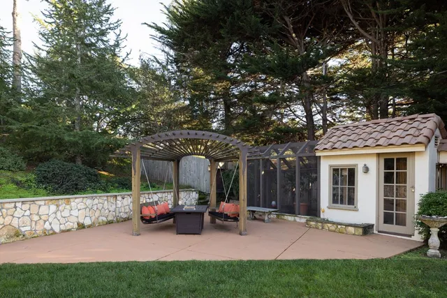 a view of a house with a patio and a garden