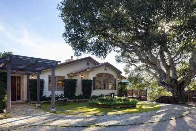 a view of a house with garden and sitting area