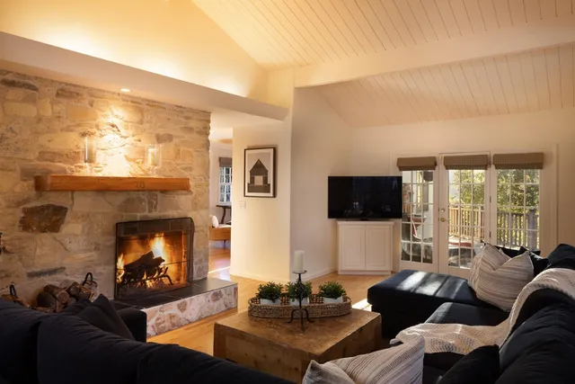 a living room with furniture a fireplace and a flat screen tv
