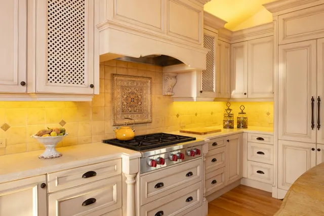 a kitchen with stainless steel appliances cabinets and a window
