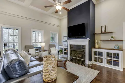 a living room with furniture a flat screen tv and a fireplace