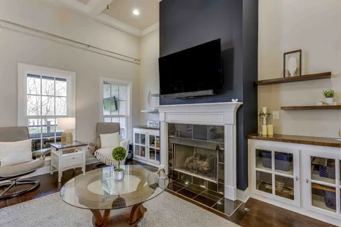 a living room with fireplace furniture and a flat screen tv