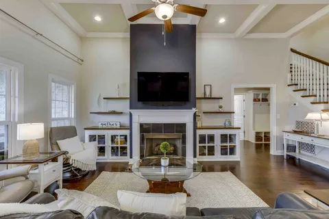 a living room with fireplace furniture and a flat screen tv