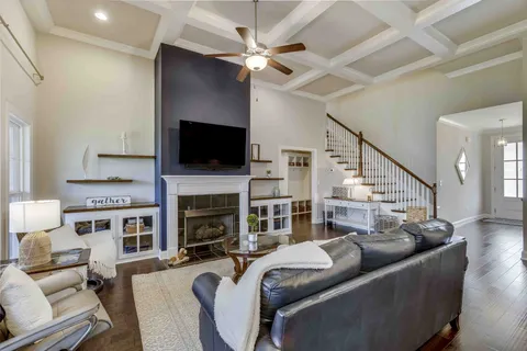 a kitchen with stainless steel appliances kitchen island granite countertop a dining table chairs and white cabinets