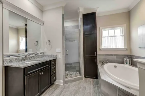 a spacious bathroom with a sink shower and a mirror