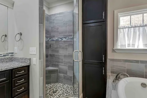 a view of walk in closet with clothes