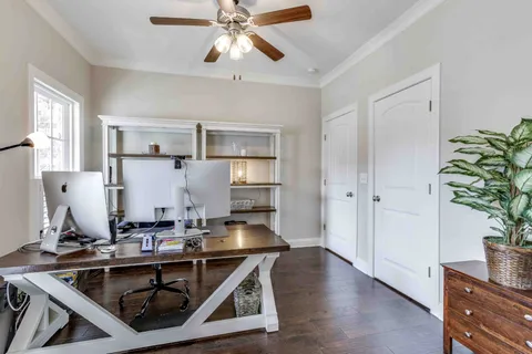 a kitchen with white cabinets and a window