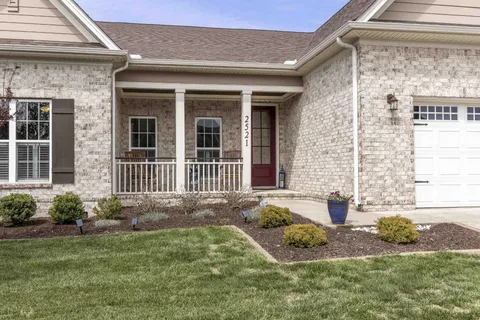 a front view of a house with garden