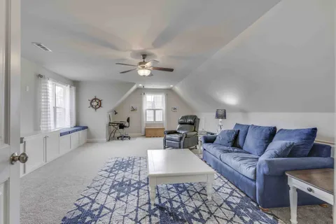 a view of a livingroom with furniture and a fireplace