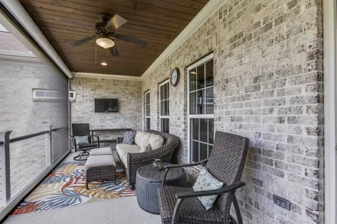 a bedroom with furniture and large windows