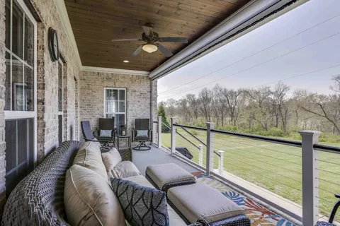 a view of a field of grass and trees
