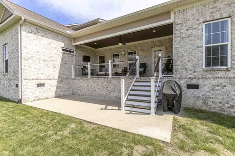 a front view of a house with a garden and deck