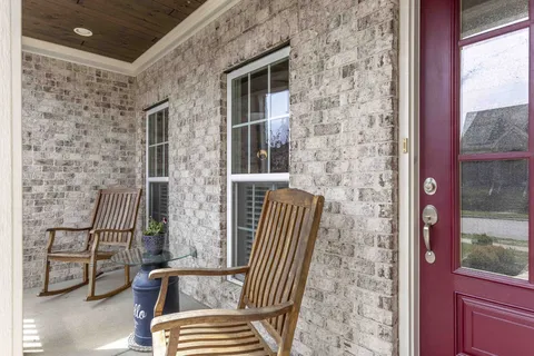 a view of front door of house with stairs