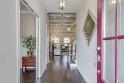 a view of entryway and hall with wooden floor