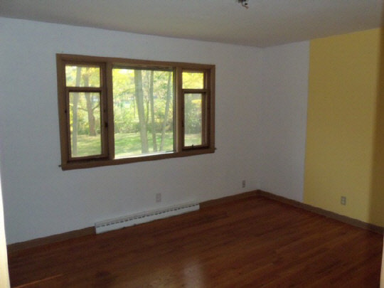 4209 Spring Creek Road Rockford, IL 61107 - Photo 5 of 11 a view of a room that has wooden floor and windows in it