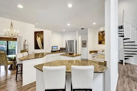 a dining room with furniture and wooden floor