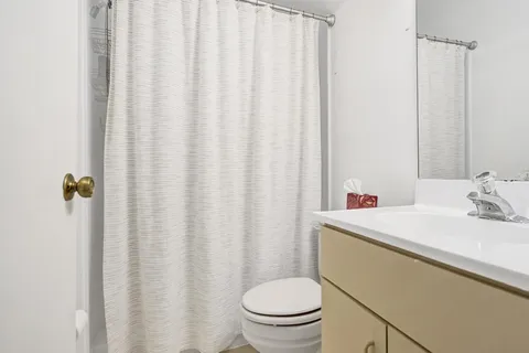 a bathroom with a toilet a sink and a shower
