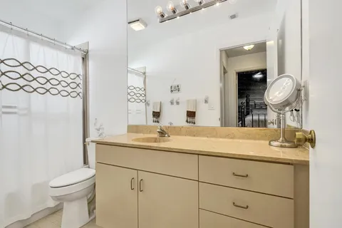 a view of a lake with table and chairs next to a yard