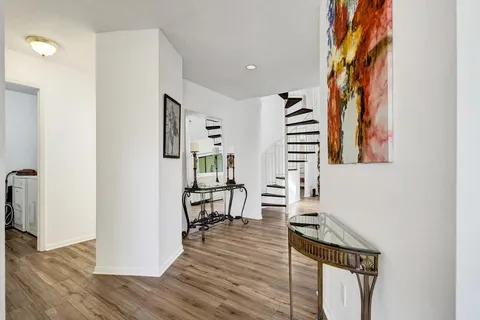 a kitchen with granite countertop stainless steel appliances a sink and a refrigerator