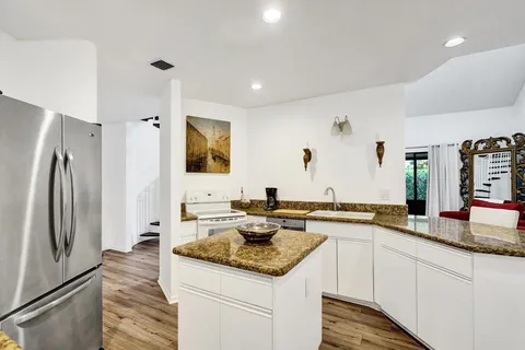 a dining room with furniture and wooden floor