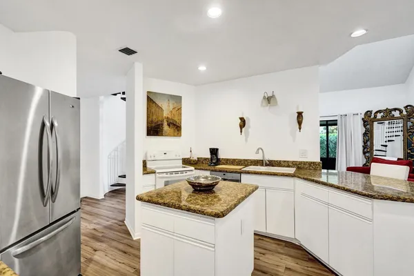 a dining room with furniture and wooden floor