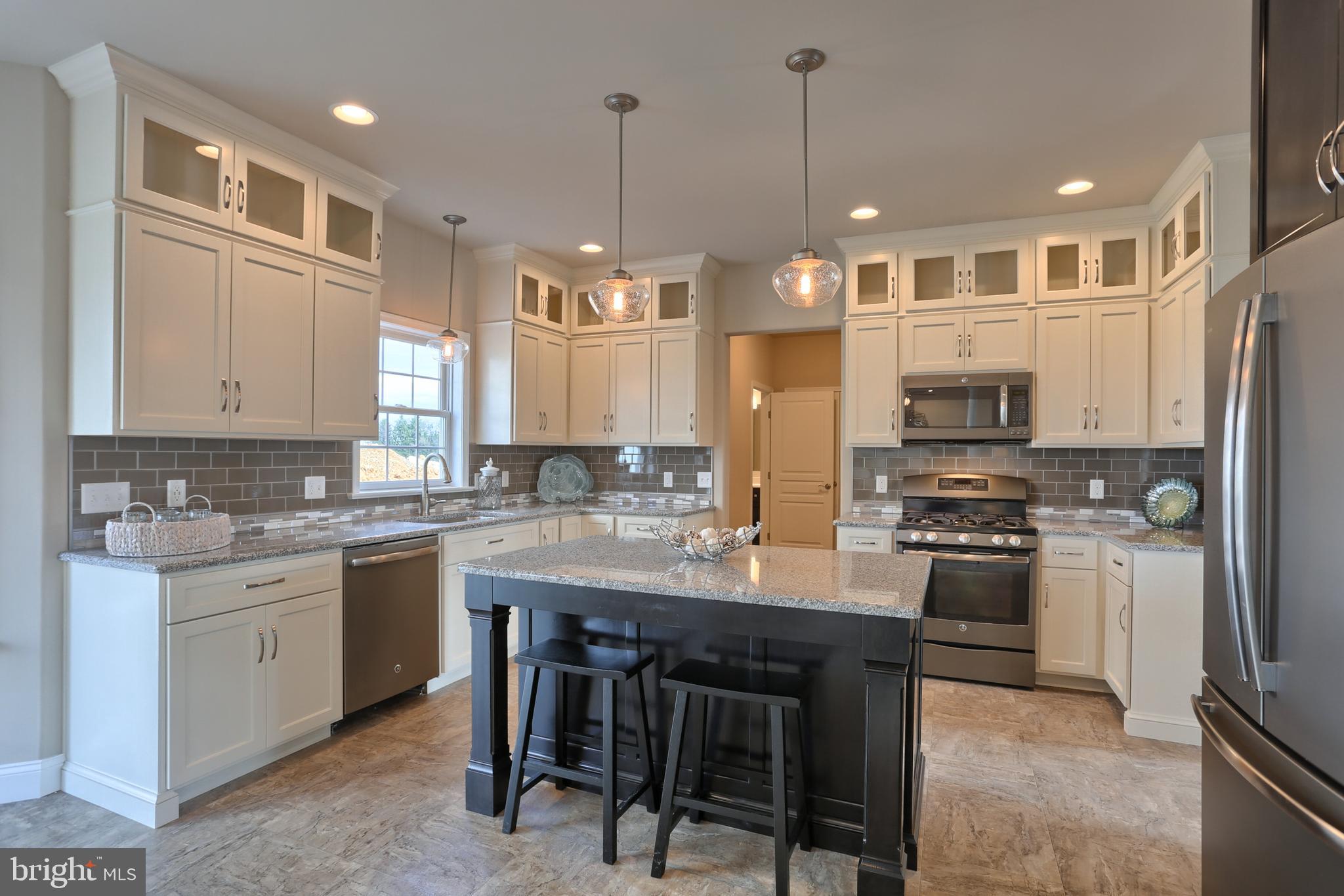 5 Rolling Meadow Road Lebanon, PA 17046 - Photo 19 of 35 a kitchen with stainless steel appliances granite countertop a sink a stove a refrigerator cabinets and chairs