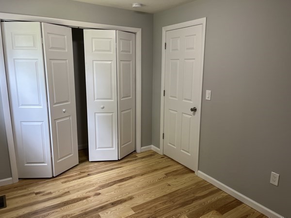 31 Meadow Road Ware, MA 01082 - Photo 16 of 22 an empty room with wooden floor and closet area