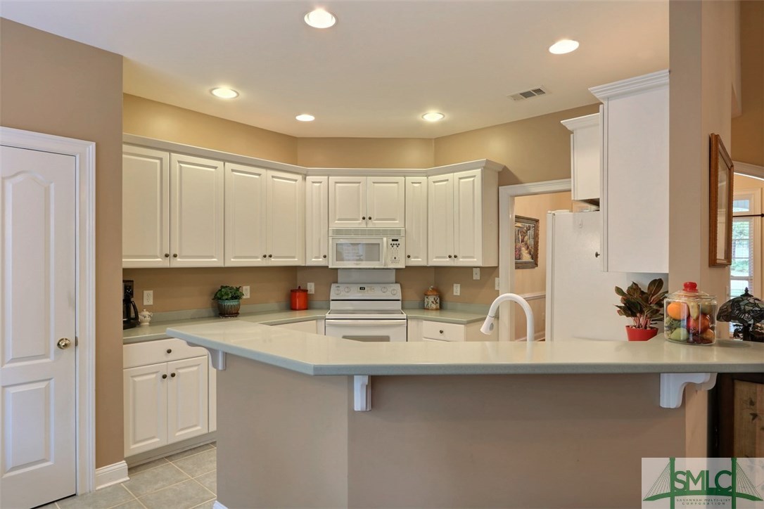 305 Erin Court Rincon, GA 31326 - Photo 7 of 30 Open Kitchen with Solid Surface Counters & Ceramic