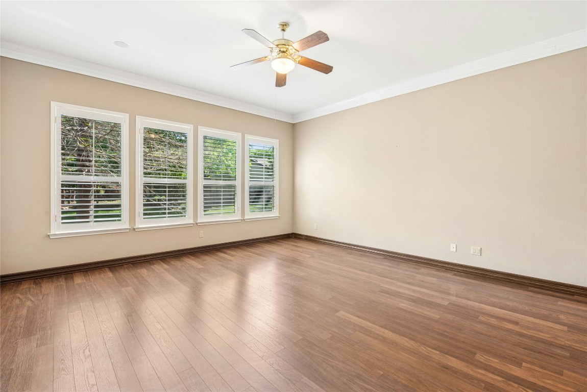 316 Trail Of The Flowers Georgetown, TX 78633 - Photo 19 of 40 a view of a room with wooden floor and a ceiling fan