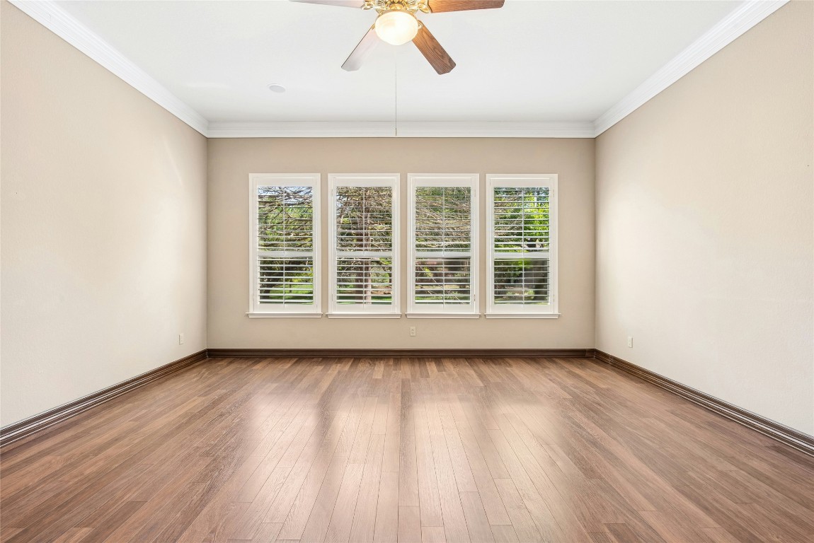 316 Trail Of The Flowers Georgetown, TX 78633 - Photo 20 of 40 a view of an empty room with wooden floor and a window