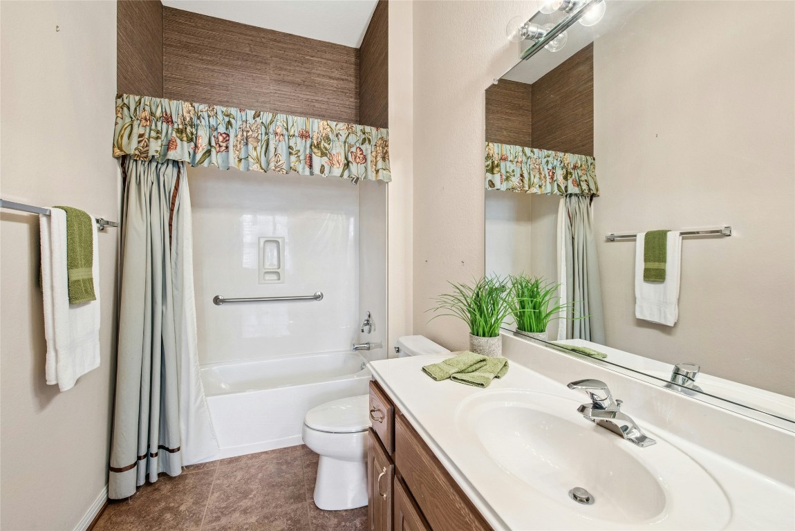 316 Trail Of The Flowers Georgetown, TX 78633 - Photo 28 of 40 a bathroom with a sink and mirror with toilet