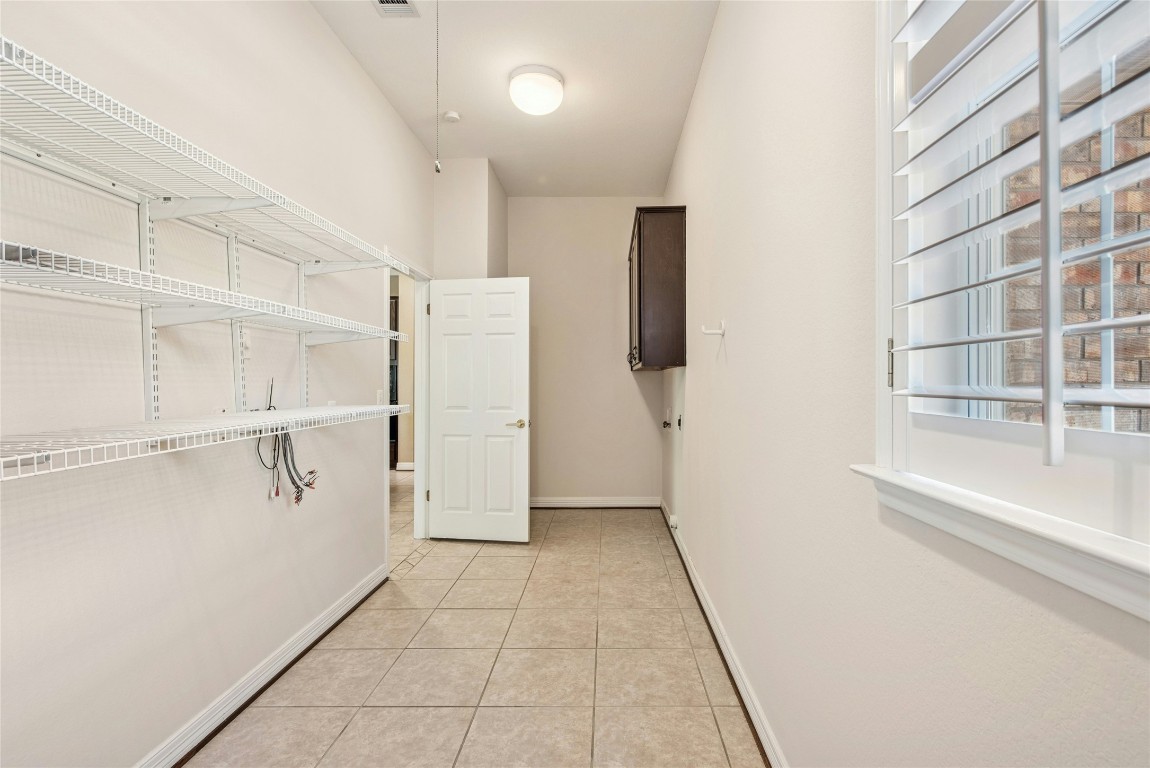 316 Trail Of The Flowers Georgetown, TX 78633 - Photo 30 of 40 a view of walk in closet with empty racks