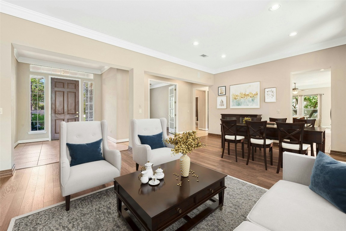 316 Trail Of The Flowers Georgetown, TX 78633 - Photo 5 of 40 a living room with furniture couches and a dining table with wooden floor