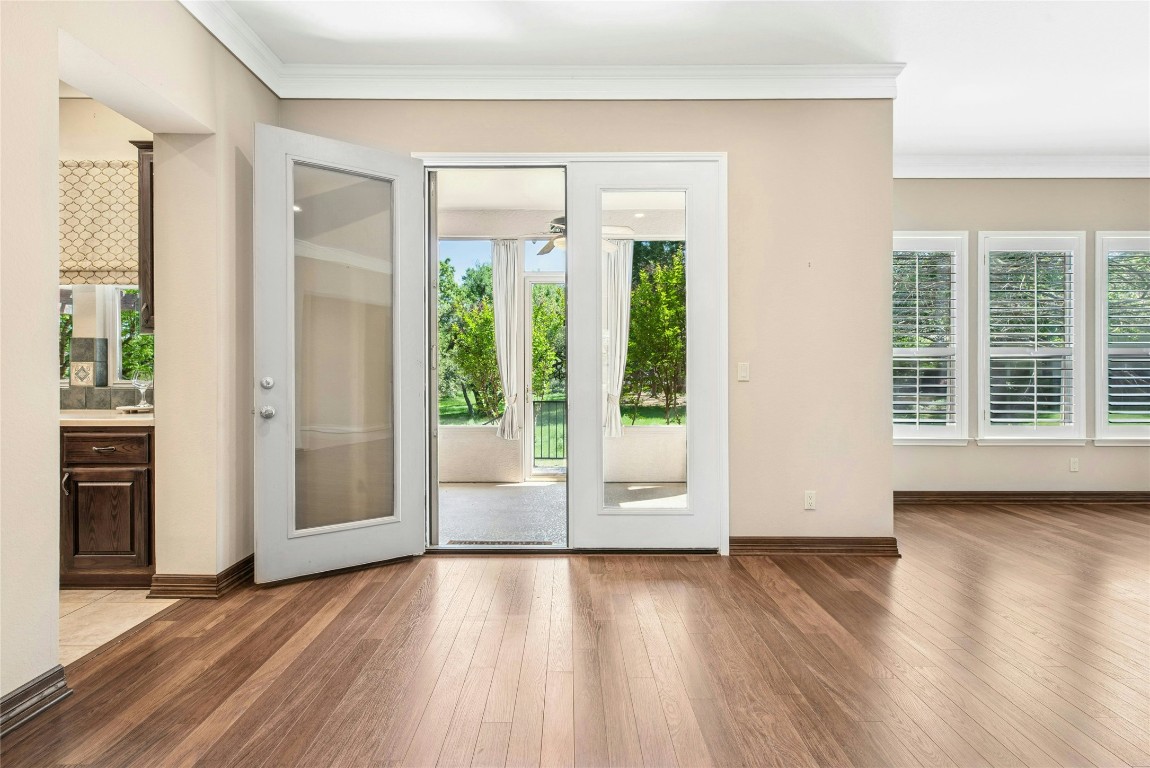 316 Trail Of The Flowers Georgetown, TX 78633 - Photo 8 of 40 a view of an empty room with wooden floor and a window