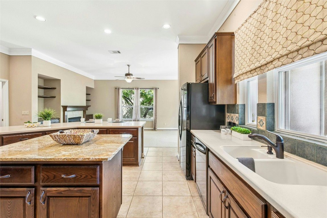 316 Trail Of The Flowers Georgetown, TX 78633 - Photo 9 of 40 a kitchen with a sink stove and cabinets
