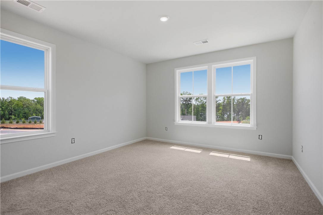 552 Hydrangea Street, Unit LOT 66 Seneca, SC 29678 - Photo 24 of 31 A well-lit room awaits your personal touch, offering abundant light through multiple windows.